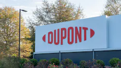 DuPont sign displayed at headquarters with bushes and trees in the background. DuPont sign displayed at headquarters with bushes and trees in the background.