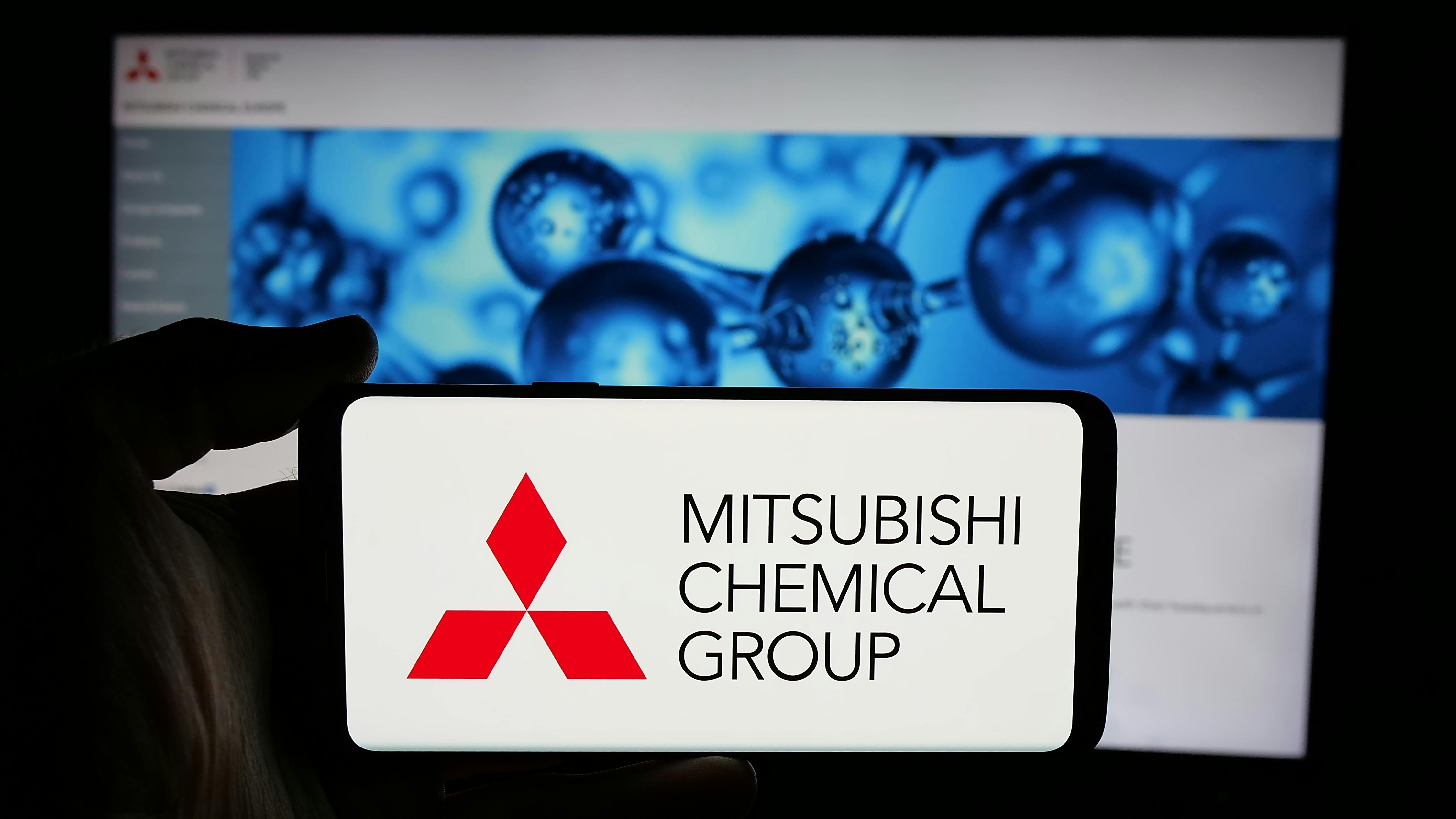 Mitsubishi Chemical Group Corporation on phone screen in front of business webpage.