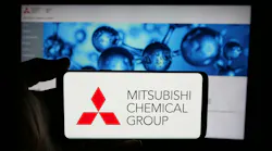 Mitsubishi Chemical Group Corporation on phone screen in front of business webpage. Mitsubishi Chemical Group Corporation on phone screen in front of business webpage.