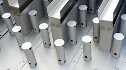 Close-up of polished metal cylindrical posts and rectangular beams bolted to an industrial steel frame. Close-up of polished metal cylindrical posts and rectangular beams bolted to an industrial steel frame.