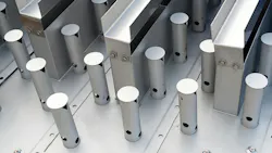 Close-up of polished metal cylindrical posts and rectangular beams bolted to an industrial steel frame.