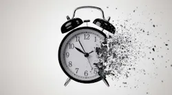 Striking monochrome image of a classic black alarm clock in the process of dissolving into a cloud of dark, gritty particles. Striking monochrome image of a classic black alarm clock in the process of dissolving into a cloud of dark, gritty particles.