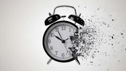 Striking monochrome image of a classic black alarm clock in the process of dissolving into a cloud of dark, gritty particles. Striking monochrome image of a classic black alarm clock in the process of dissolving into a cloud of dark, gritty particles.