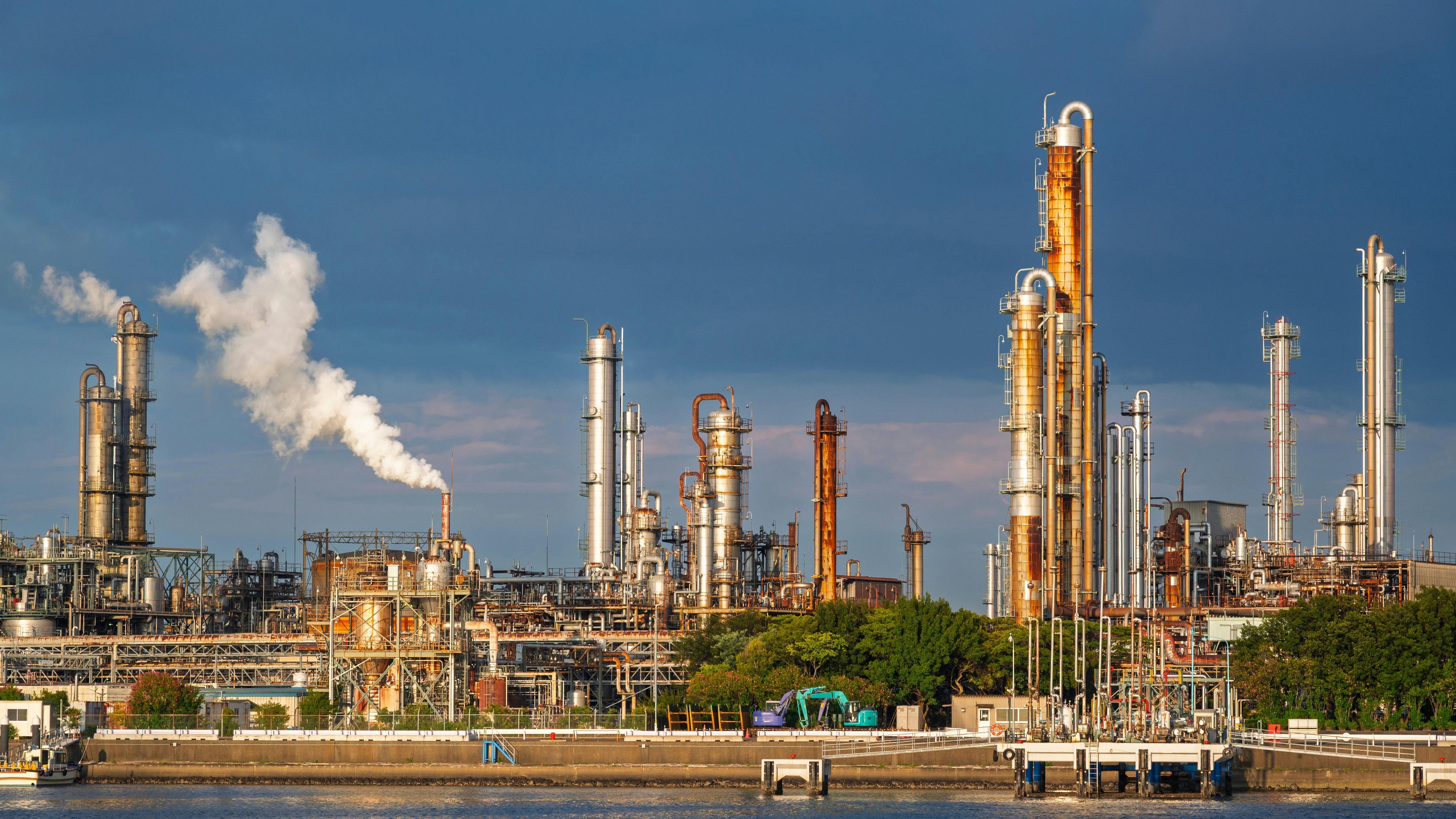 equipment of gas oil refining plant in Japan industrial factory area with blue sky background view from Fishing port, Yokkaichi, Mie Prefecture, Japan.