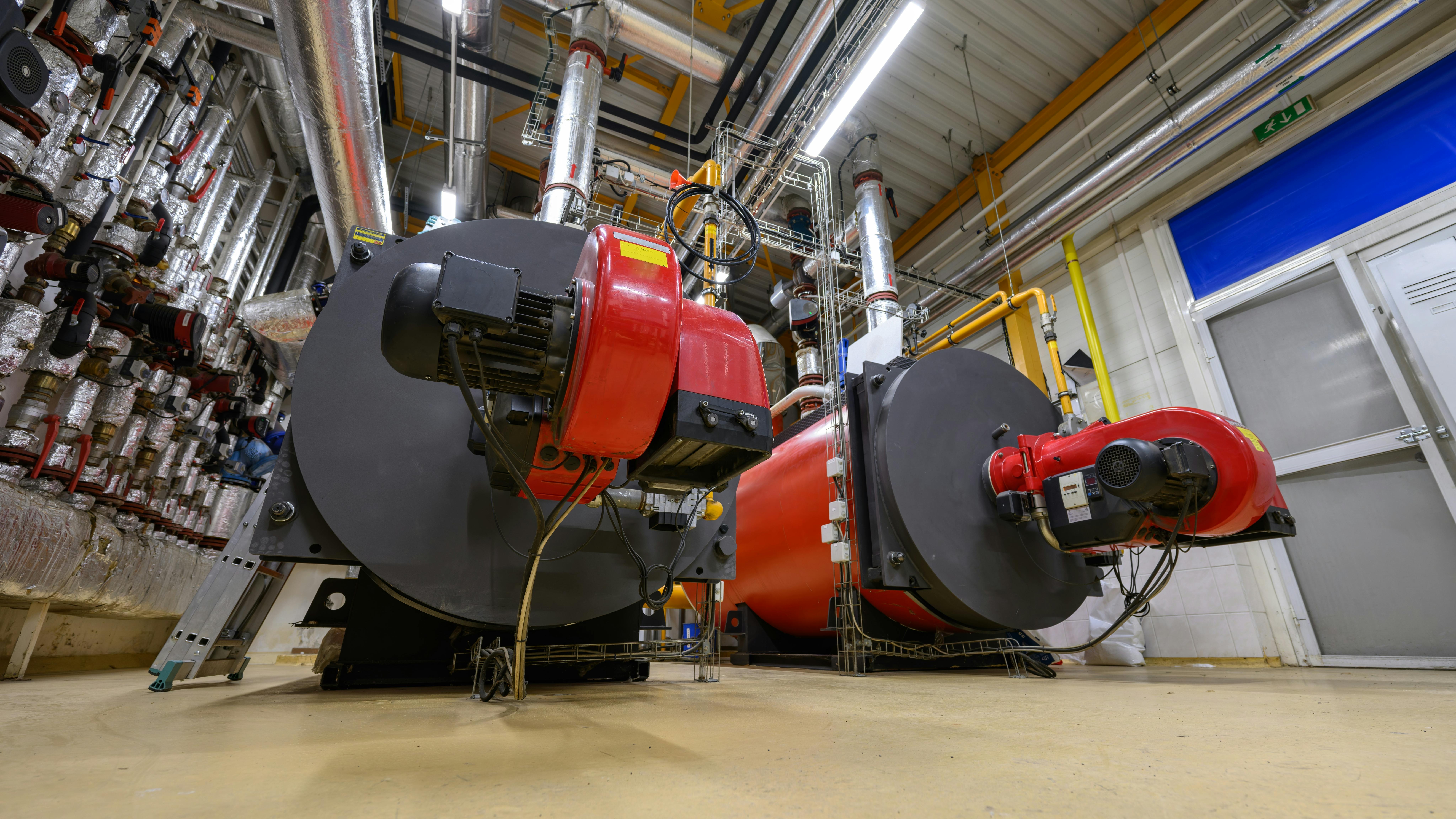 Gas steam boilers in an industrial boiler room.