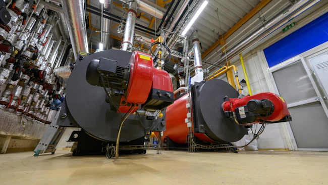 Gas steam boilers in an industrial boiler room.