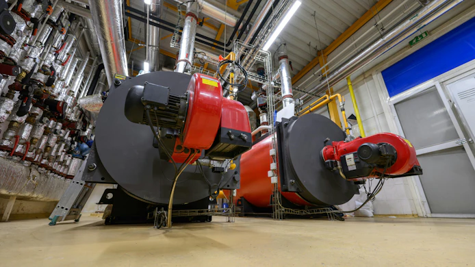 Gas steam boilers in an industrial boiler room.