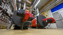 Gas steam boilers in an industrial boiler room. Gas steam boilers in an industrial boiler room.