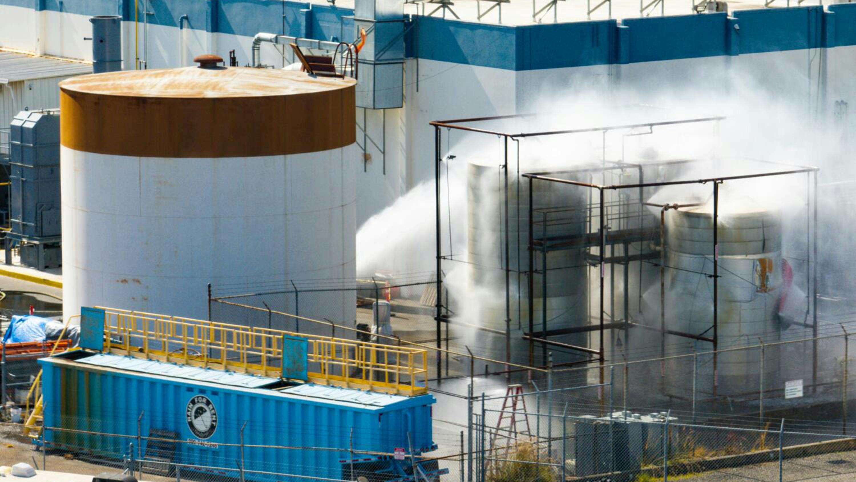 An aerial of water being sprayed on large storage tanks at the GKN Aerospace facility on Sunday, May 24, 2026, in Garden Grove, Calif. (Kayla Bartkowski/Los Angeles Times/TNS)