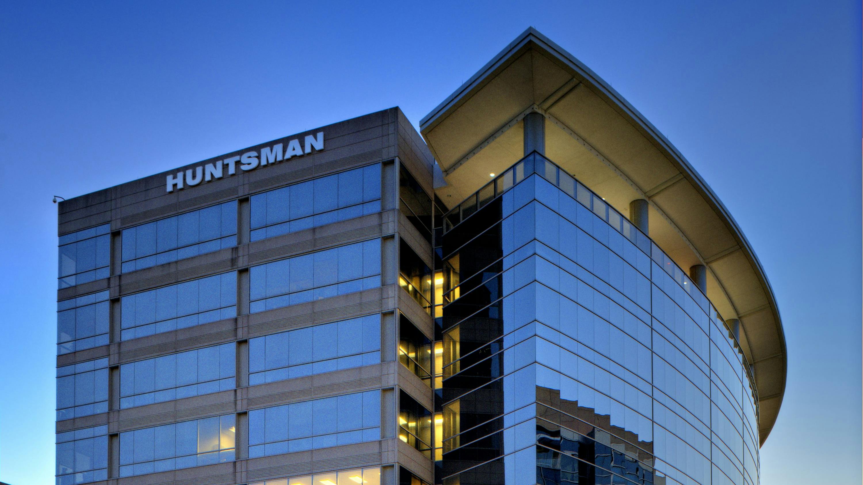 Huntsman headquarters building in The Woodlands, Texas against a blue sky