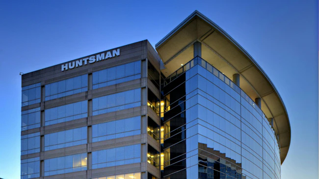 Huntsman headquarters building in The Woodlands, Texas against a blue sky