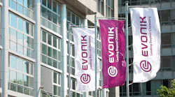 Three Evonik logo flag banners at company headquarters in Germany Three Evonik logo flag banners at company headquarters in Germany