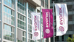Three Evonik logo flag banners at company headquarters in Germany Three Evonik logo flag banners at company headquarters in Germany