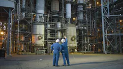 Two workers stand in front of Chemours Washington Works chemical facility Two workers stand in front of Chemours Washington Works chemical facility