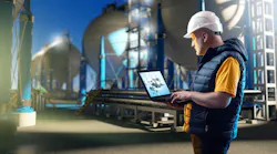 Engineering specialist near gas storage with spherical tanks for storing liquefied gas in the background at night