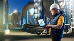 Engineering specialist near gas storage with spherical tanks for storing liquefied gas in the background at night Engineering specialist near gas storage with spherical tanks for storing liquefied gas in the background at night