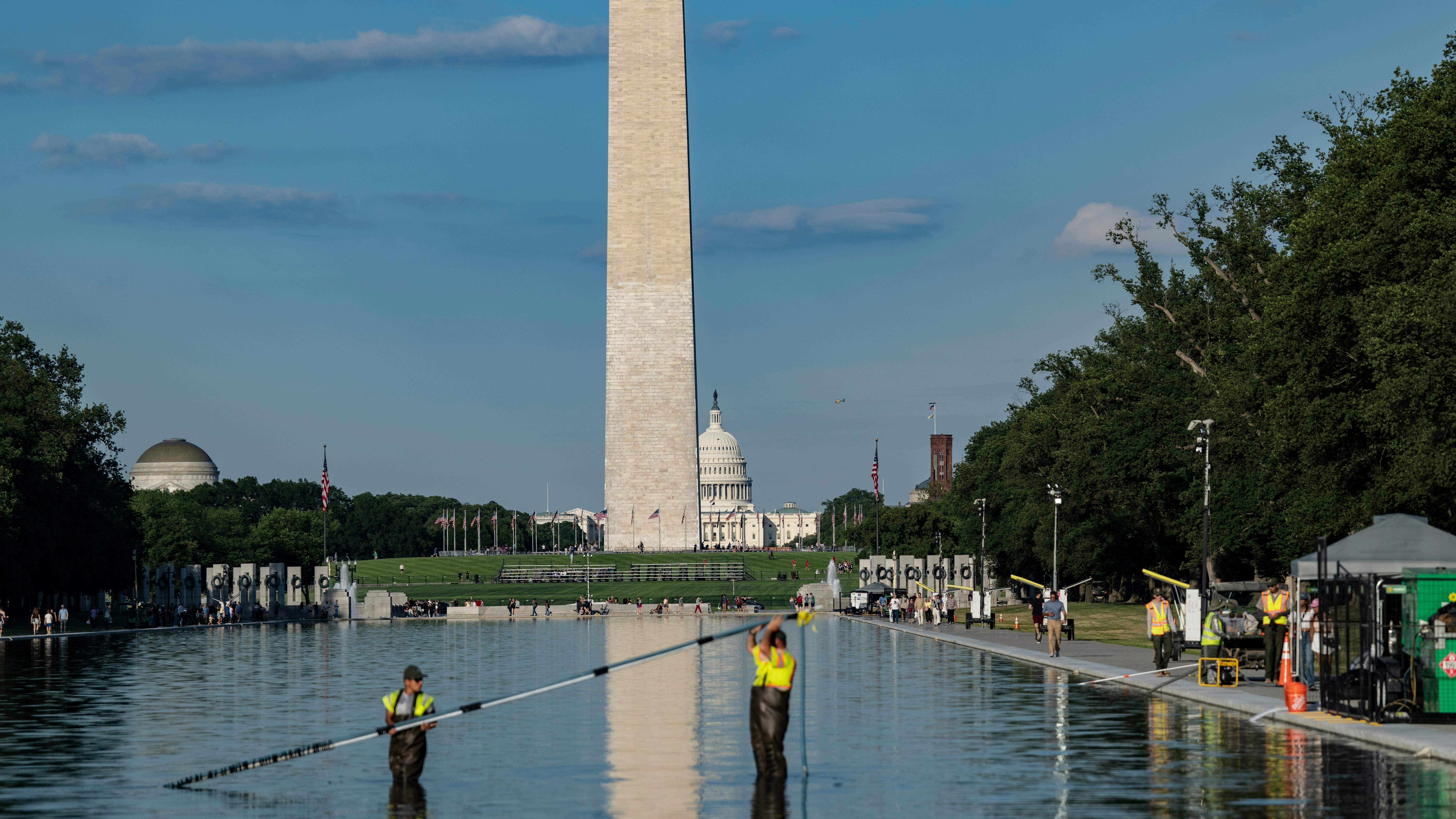 Lincoln Memorial Reflecting Pool with two workers seen cleaning it up