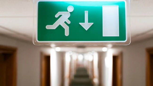 Exit sign in hotel hallway