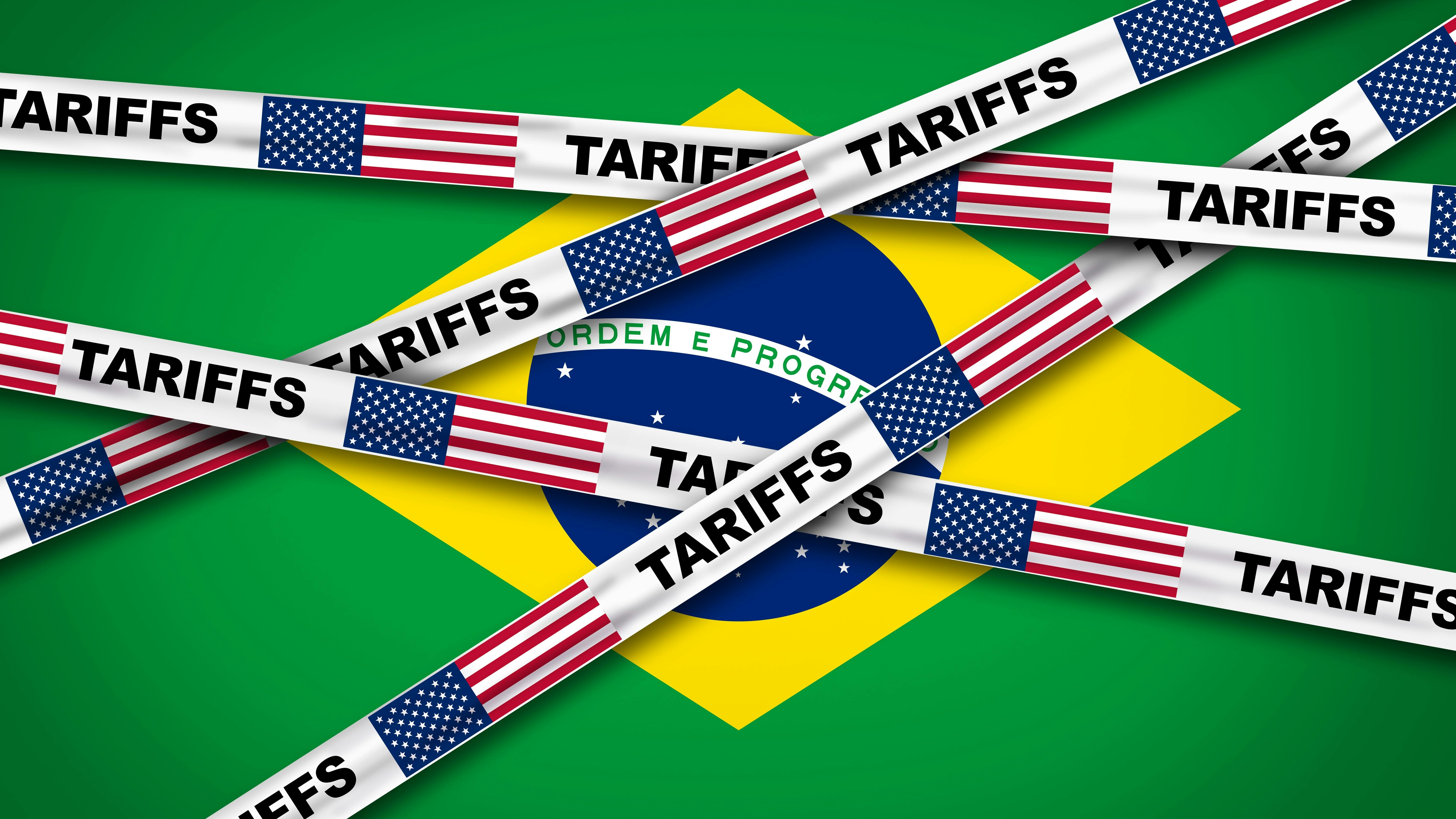 Illustration of the Brazilian flag partially covered by tape strips labeled &lsquo;Tariffs&rsquo; featuring U.S. flags, symbolizing U.S. trade tariffs on Brazilian imports and trade tensions between the two countries.