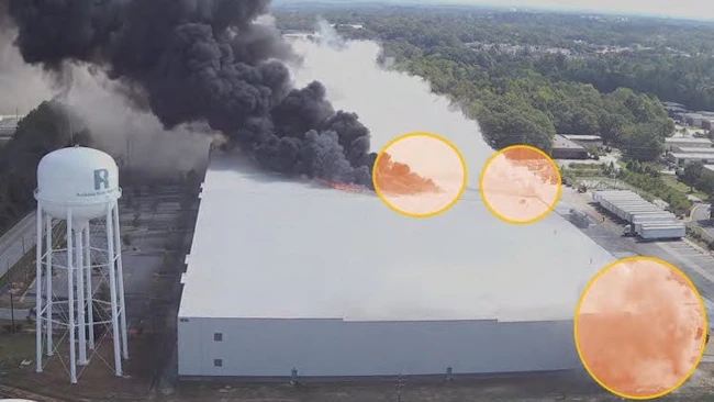 Aerial shot of the second building fire at Bio-Lab Conyers 12 Storage Warehouse on September 29, 2024, resulting from the multiple-point heat source generated by decomposing oxidizers and combustible materials. (Credit: RCFR, annotated by CSB)