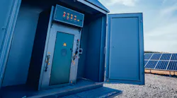 power grid control cabinet with solar panels in background