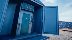 power grid control cabinet with solar panels in background