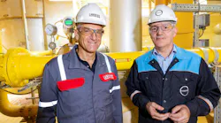 Michael Ertl, Head of LANXESS' Inorganic Pigments business unit, and Rob Eek, Production Manager at Covestro in Krefeld-Uerdingen, stand in front of the new hydrogen pipeline serving LANXESS' iron oxide plant.
