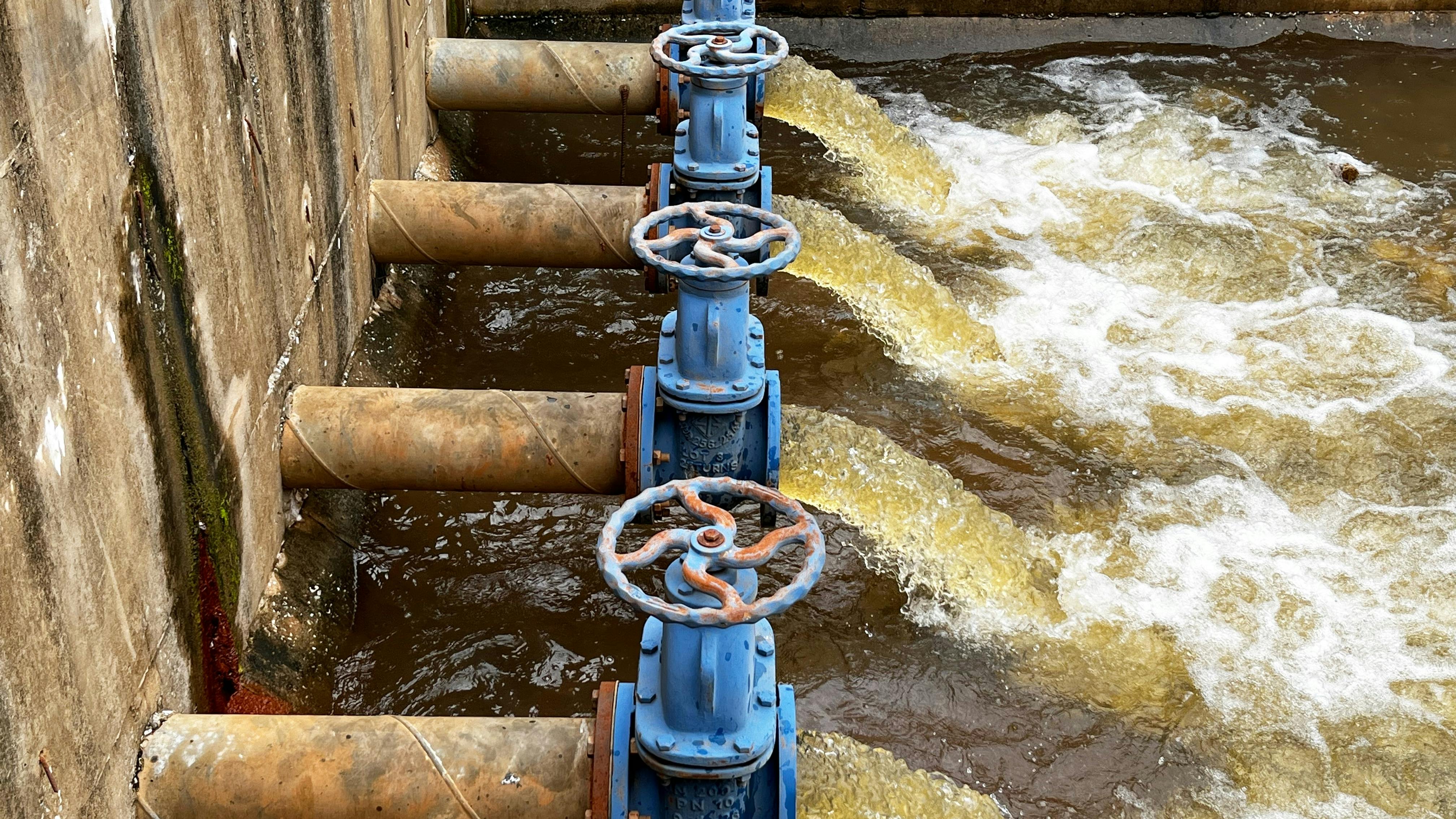 Blue pumps and valves discharge industrial wastewater