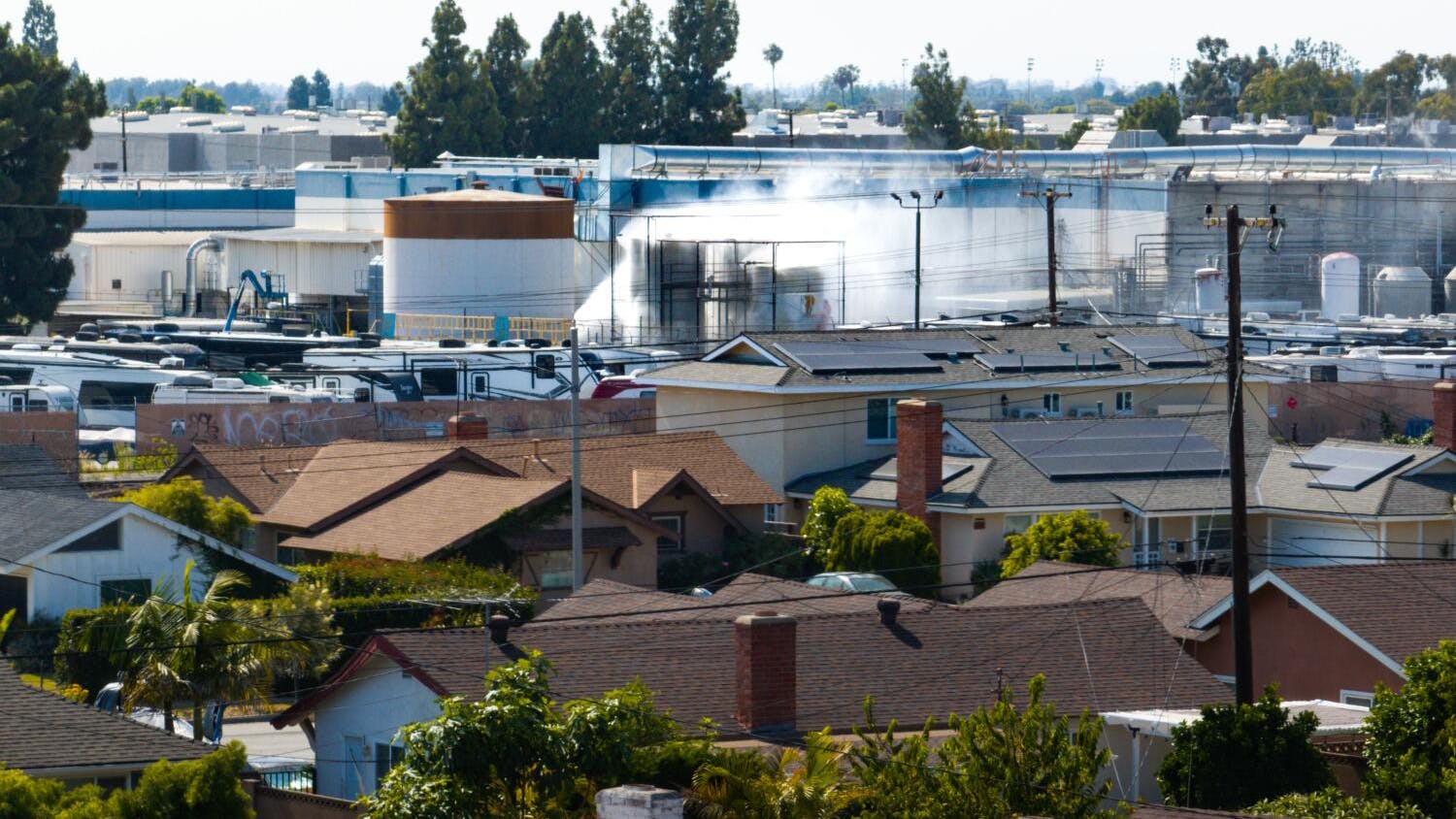 GARDEN GROVE, CA - MAY 24, 2026: An aerial of water being sprayed on large storage tanks at the GKN Aerospace facility on Sunday, May 24, 2026, in Garden Grove, CA. 44,000 people remain evacuated after a 34,000-gallon tank of methyl methacrylate (MMA) leaked at a garden Grove aerospace plastics facility, sending potentially toxic vapors into the air on Thursday.