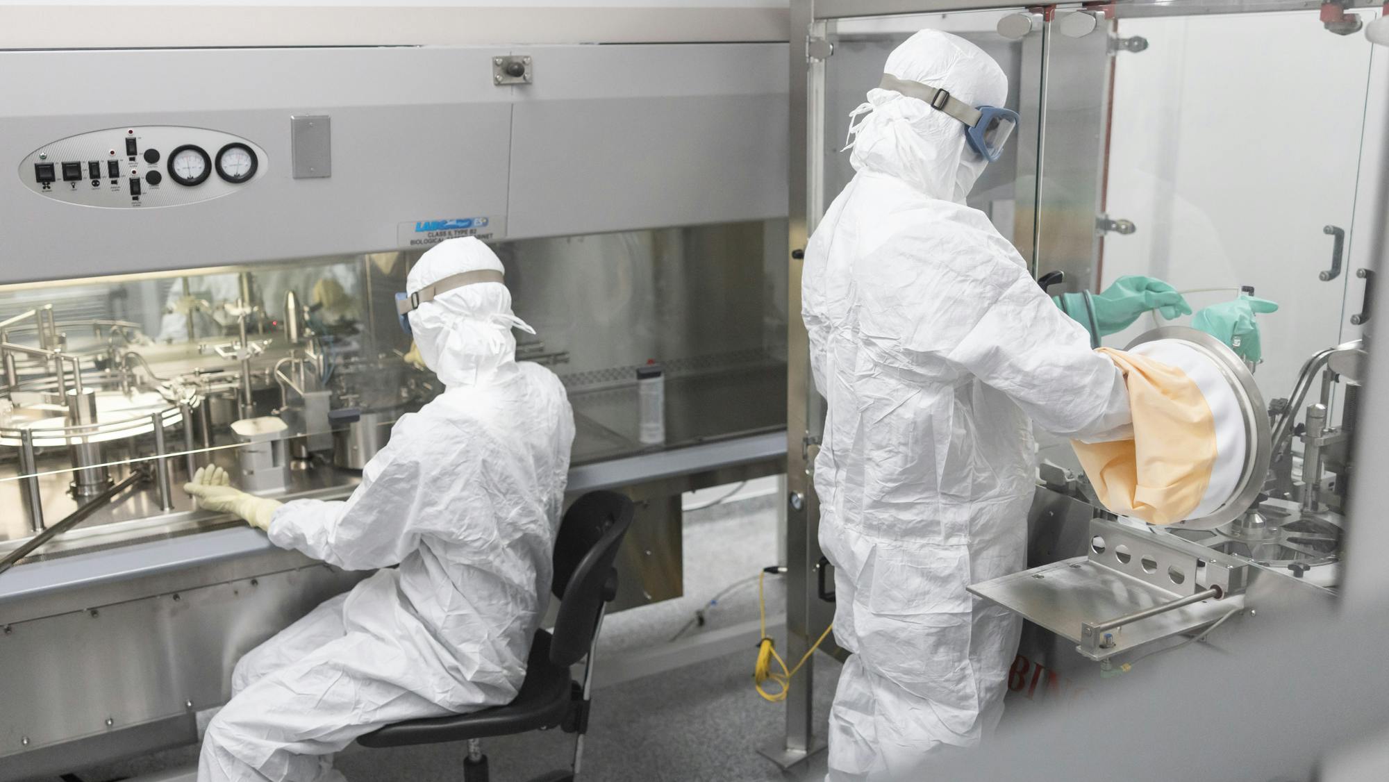 Two pharmaceutical workers in PPE at Evonik facility