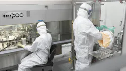 Two pharmaceutical workers in PPE at Evonik facility