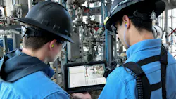 Young workers review tablet with digital similation of plant