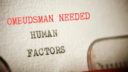 Paper in typewritter with words Humans Factors, and above it in red, Ombudsman Needed
