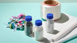 Products from each stage of the process, in which waste banners are finely shredded, chemically recycled into recycled materials, spun into yarn, and made into banners.