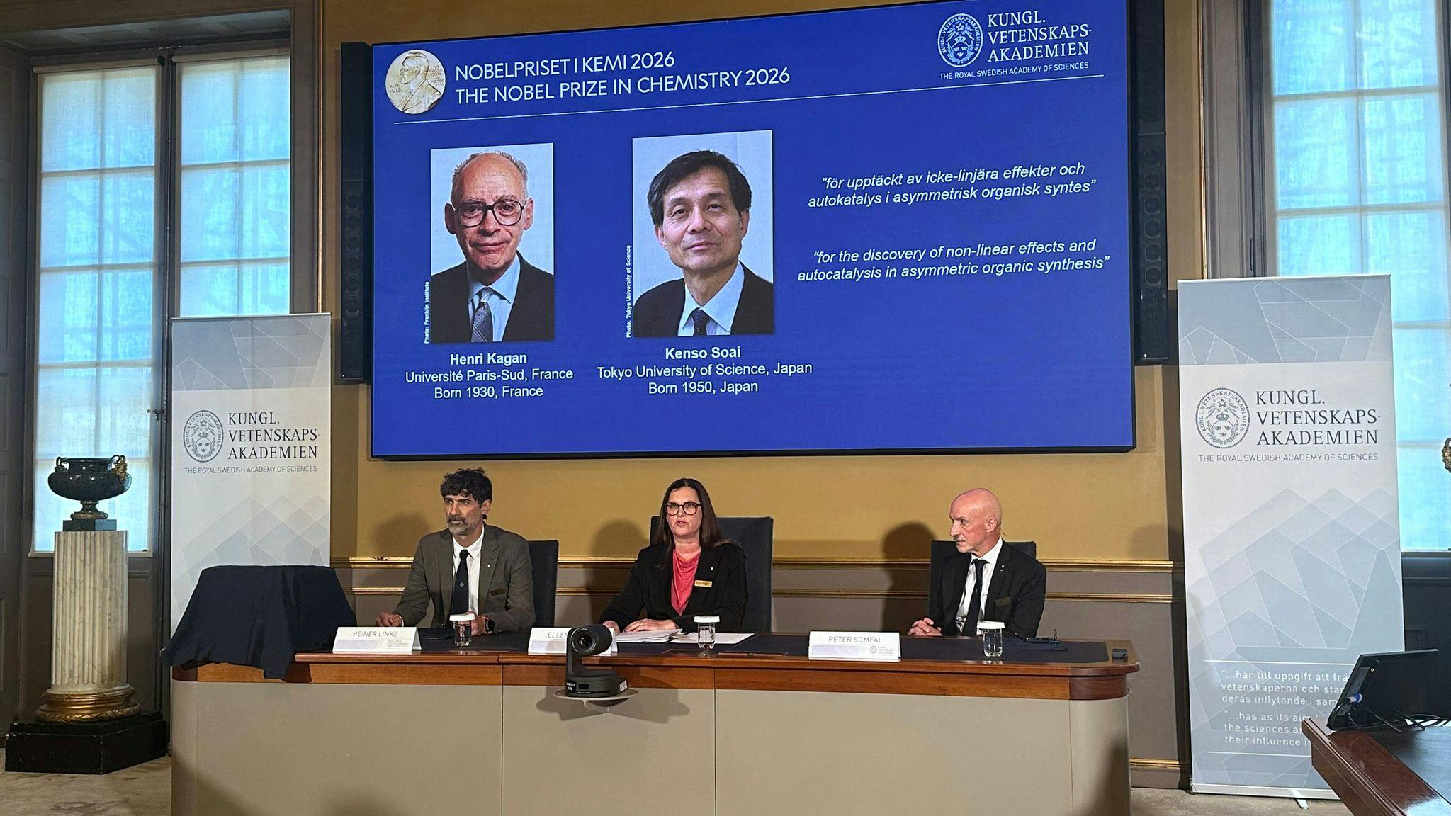 Heiner Linke (front, l-r), Chair of the Nobel Committee for Chemistry; Ellen Moons, Secretary General of the Royal Swedish Academy of Sciences (KVA); and Peter Somfai, member of the Nobel Committee for Chemistry, are seated at the Royal Swedish Academy of Sciences (KVA) during the announcement of this year&rsquo;s Nobel Prize laureates in Chemistry, Henri Kagan ( France) and Kenso Soai ( Japan), who are shown on a display, at the Royal Swedish Academy of Sciences (KVA).