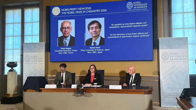 Heiner Linke (front, l-r), Chair of the Nobel Committee for Chemistry; Ellen Moons, Secretary General of the Royal Swedish Academy of Sciences (KVA); and Peter Somfai, member of the Nobel Committee for Chemistry, are seated at the Royal Swedish Academy of Sciences (KVA) during the announcement of this year&rsquo;s Nobel Prize laureates in Chemistry, Henri Kagan ( France) and Kenso Soai ( Japan), who are shown on a display, at the Royal Swedish Academy of Sciences (KVA).