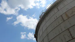 Corrosion on tank agains blue sky and clouds
