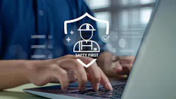 Person using a laptop with a digital safety interface overlay featuring a hard hat, protective shield, checkmark and the words ‘Safety First,’ representing workplace safety management and risk prevention